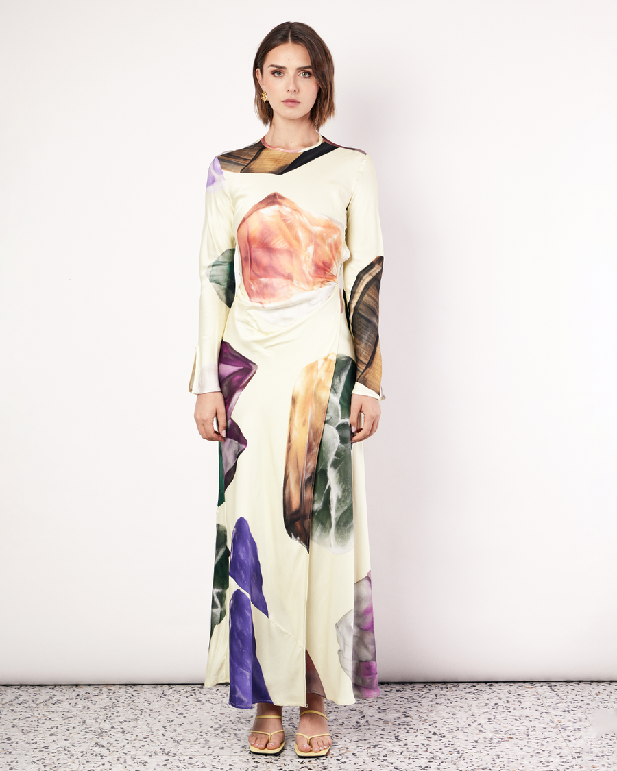 The Gemstone Wrap Dress boasts a fluid form and elevated style, featuring gathered detailing and a leg split. It is crafted from a silky recycled Oeko-Tex® certified viscose in the Gemstone Print, designed exclusively for Romy. Now available at Romy. 