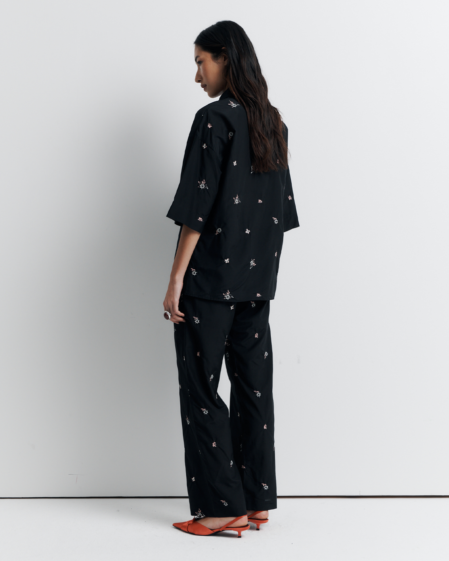 The June Shirt is an oversized short sleeve button-up featuring a concealed placket, exaggerated sleeves, and delicate floral embroidery for a subtle romantic touch. Pair it with the matching pant or wear it open over a tank for easy styling. Shop now.