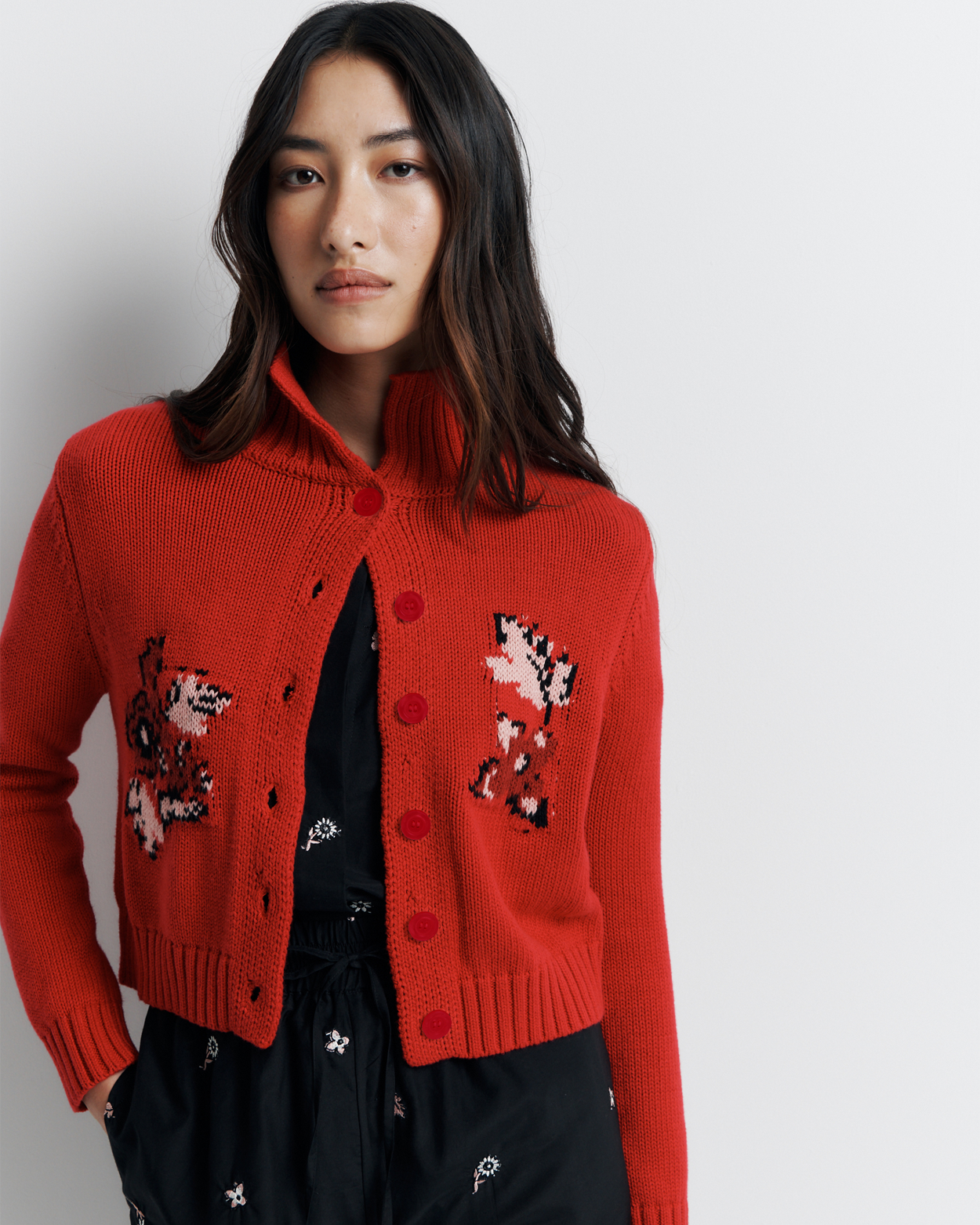 The Lara Cardigan is a fitted, collared knit featuring delicate floral motifs and a timeless button-front design—perfect for layering with a touch of vintage charm.