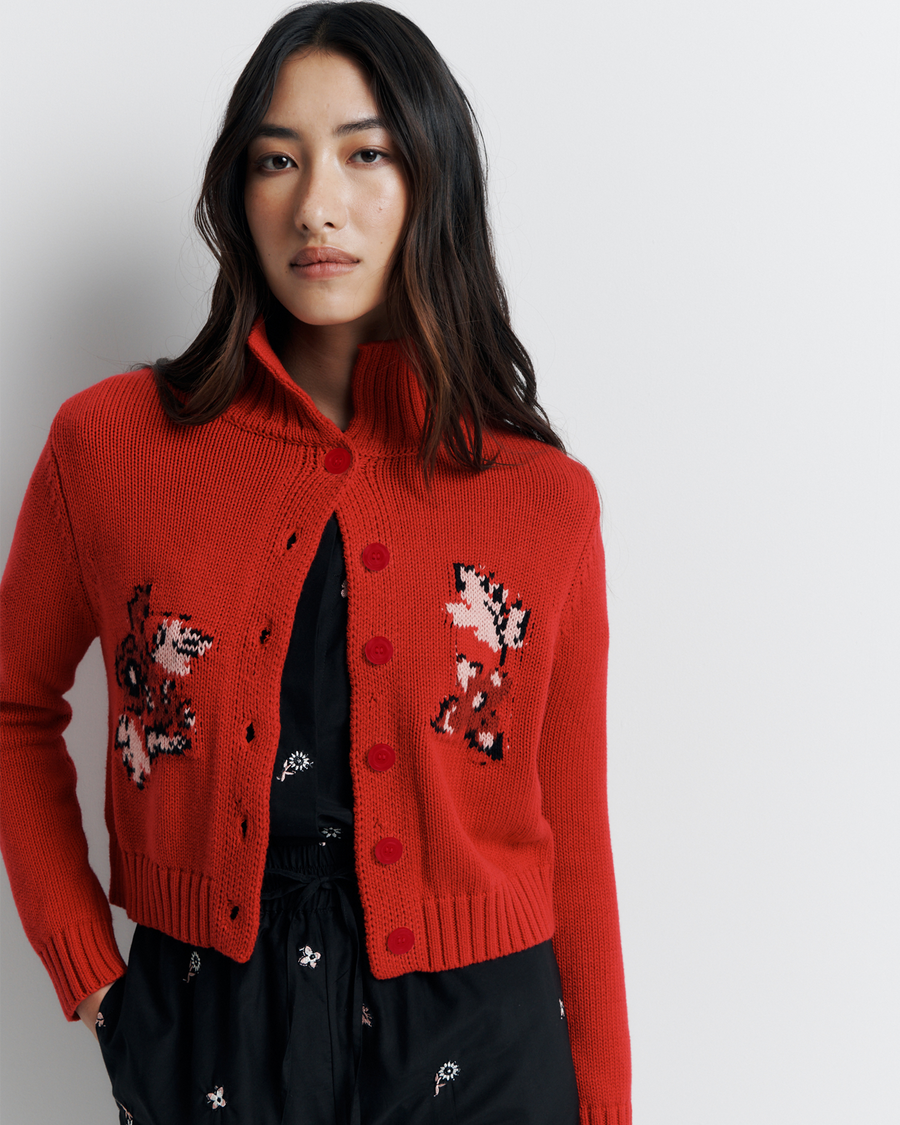 The Lara Cardigan is a fitted, collared knit featuring delicate floral motifs and a timeless button-front design—perfect for layering with a touch of vintage charm.