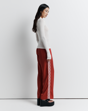 The Louise Knit Top in White is a collared Henley-style knit featuring soft bust gathers, elongated sleeves for layering, and signature ‘R’ embroidery—an effortlessly polished wardrobe essential.