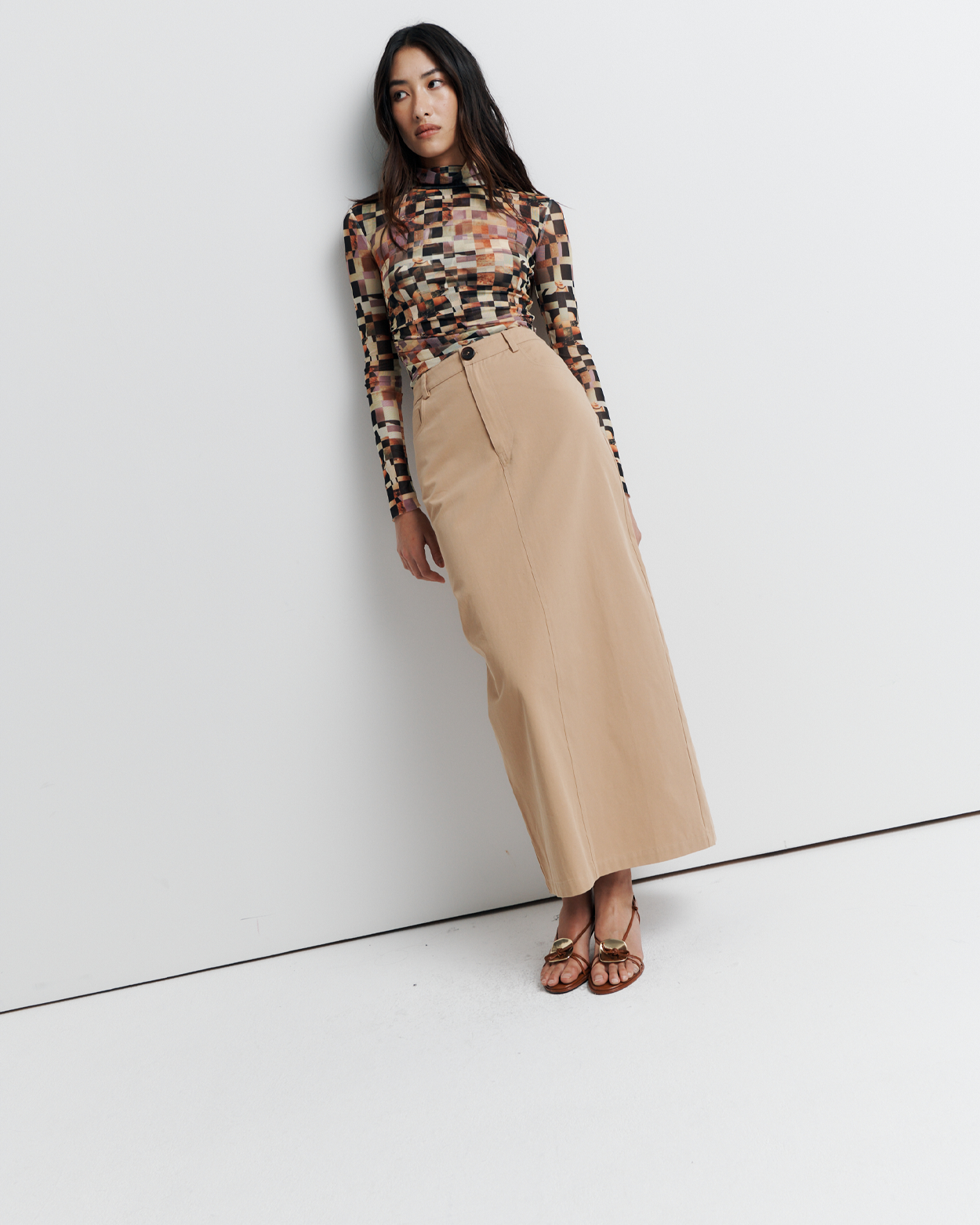 Discover the Rowie Skirt – a chic column-style skirt crafted from soft cotton twill. Features belt loops, pockets, and a zippered fly for effortless style and comfort.
