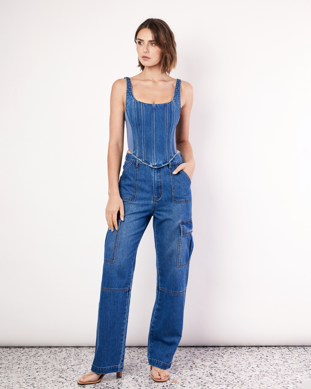 The Denim Bustier is a structured top, featuring adjustable straps, boning detail through the front, a zip closure and dipped waist to flatter your waistline. The side panels are made from scuba fabric that mould to the body and hug you in. Now available at Romy.