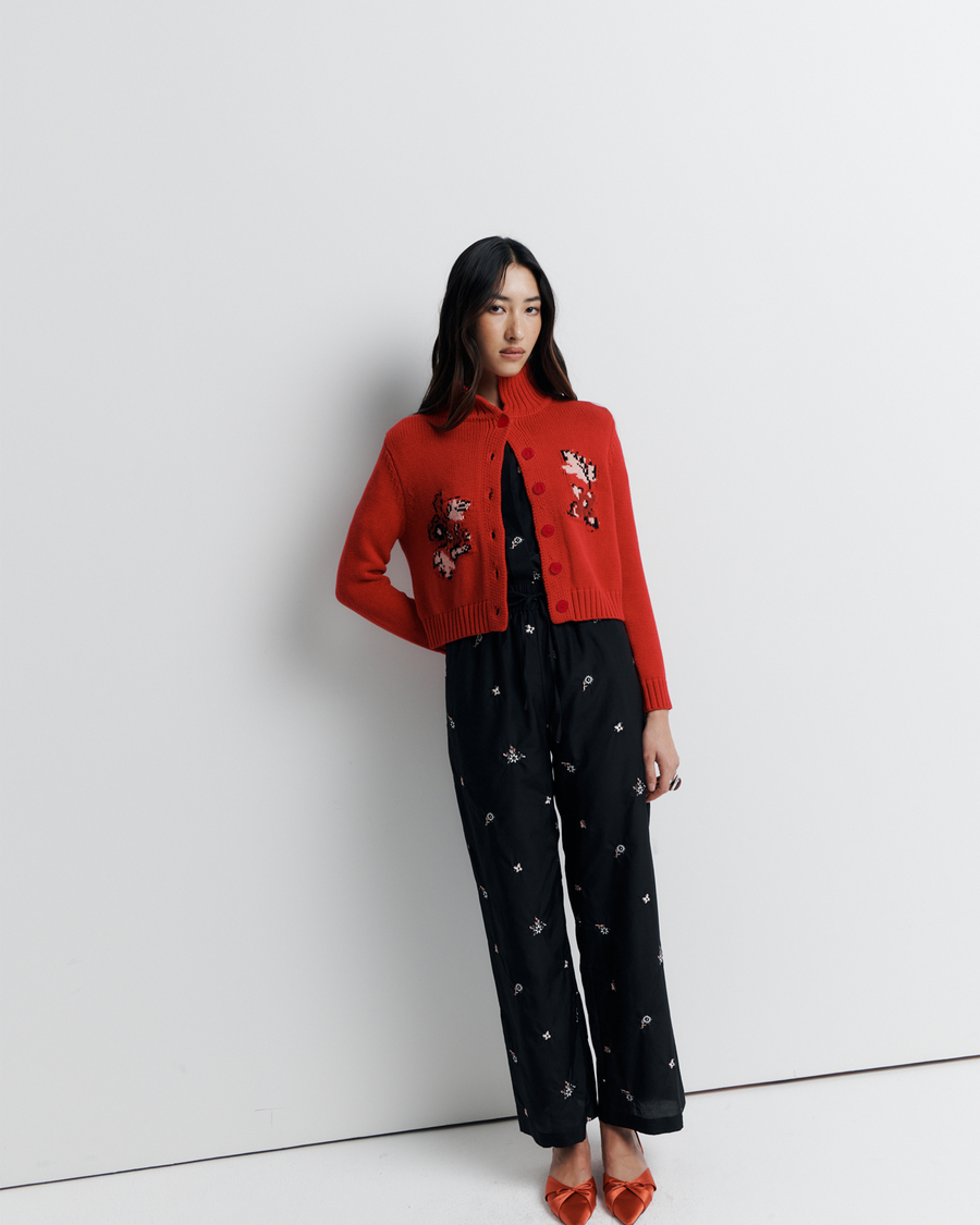 The Lara Cardigan is a fitted, collared knit featuring delicate floral motifs and a timeless button-front design—perfect for layering with a touch of vintage charm.