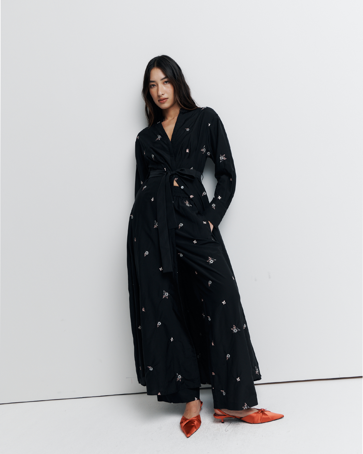 The Lola Shirt Dress is a lightweight, button-through shirtdress featuring pleated waist detailing, a removable belt, and delicate floral embroidery for a romantic, feminine finish.