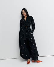 The Lola Shirt Dress is a lightweight, button-through shirtdress featuring pleated waist detailing, a removable belt, and delicate floral embroidery for a romantic, feminine finish.
