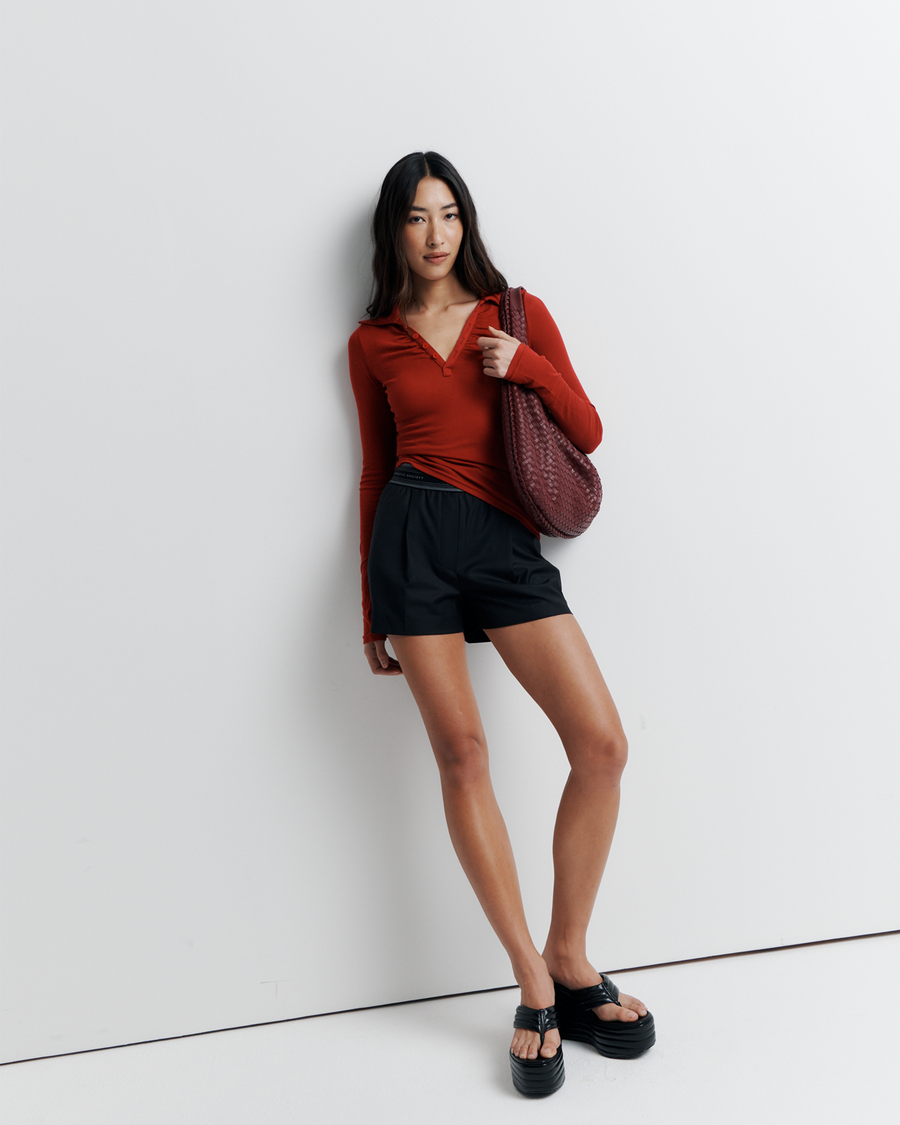 The Louise Knit Top in Red is a collared Henley-style knit featuring soft bust gathers, elongated sleeves for layering, and signature ‘R’ embroidery—an effortlessly polished wardrobe essential.