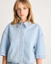 This Denim Shirt is a take on a Romy Classic in a light blue wash in a 100% cotton. It an elevated take on your staple denim shirt that can be styled fastened or open over any dress or tank. Shop now.