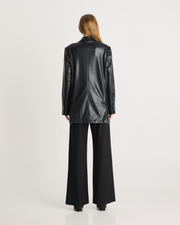 The Vegan Leather Boxy Blazer is a relaxed, oversized silhouette, featuring front pockets and a button closure. It is fully lined and is crafted from a buttery soft Vegan leather fabrication in Black. Now available at Romy. 