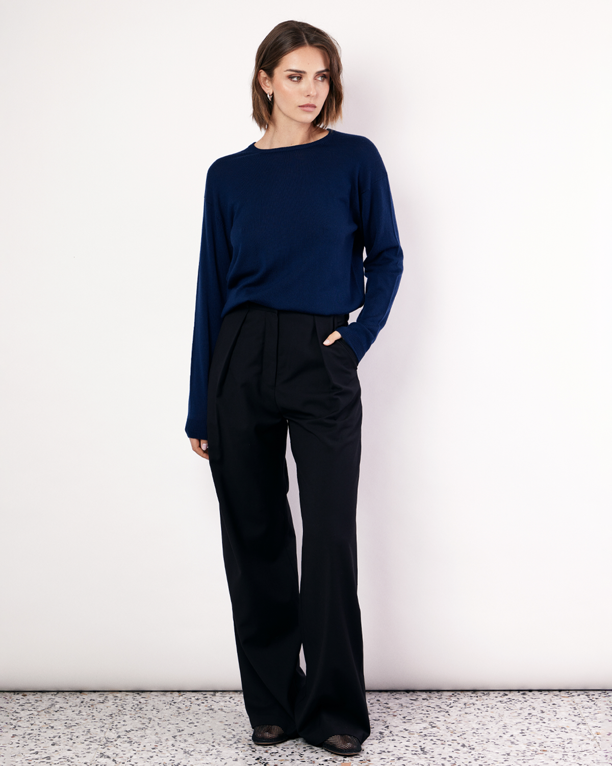 The Crew Neck Sweater is an everyday lightweight knit, featuring ribbed collar, cuff and hem detailing. It is crafted from 100% Extra Fine Merino Wool in Navy. Now available at Romy. 