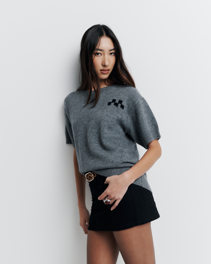 Shop the Cleo Short Sleeve Sweater made from a luxurious 90% wool and 10% cashmere blend. Featuring a relaxed fit, dropped shoulders, crew neck, and ribbed hem detailing, this lightweight, breathable sweater adds comfort and style to your wardrobe. Perfect for layering or wearing on its own.