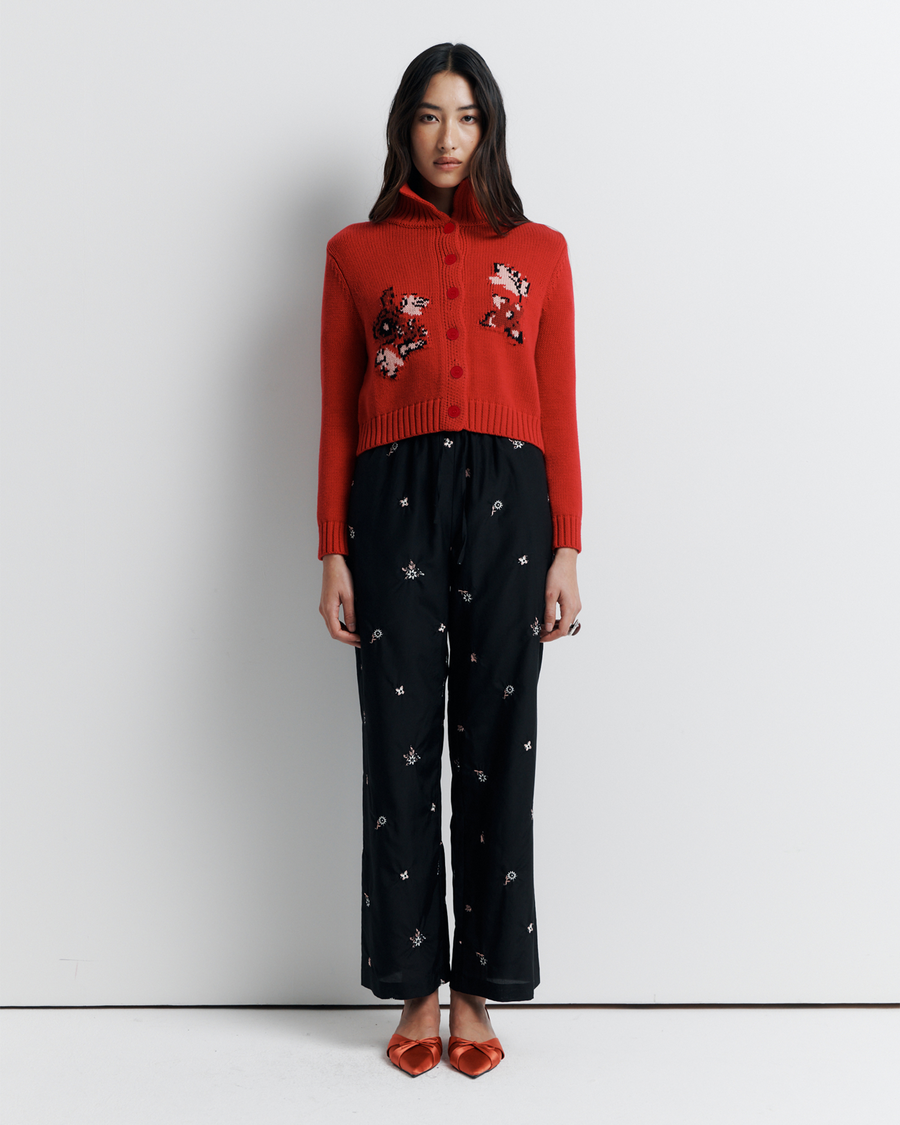 The Lara Cardigan is a fitted, collared knit featuring delicate floral motifs and a timeless button-front design—perfect for layering with a touch of vintage charm.