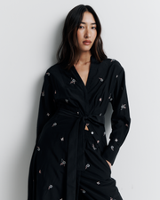 The Lola Shirt Dress is a lightweight, button-through shirtdress featuring pleated waist detailing, a removable belt, and delicate floral embroidery for a romantic, feminine finish.