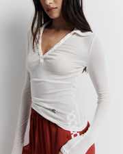 The Louise Knit Top in White is a collared Henley-style knit featuring soft bust gathers, elongated sleeves for layering, and signature ‘R’ embroidery—an effortlessly polished wardrobe essential.