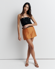 The Jade Skirt is a mini style with belt loops and contouring panel lines for a flattering, curve-enhancing fit—finished with delicate floral embroidery for a subtle romantic touch.