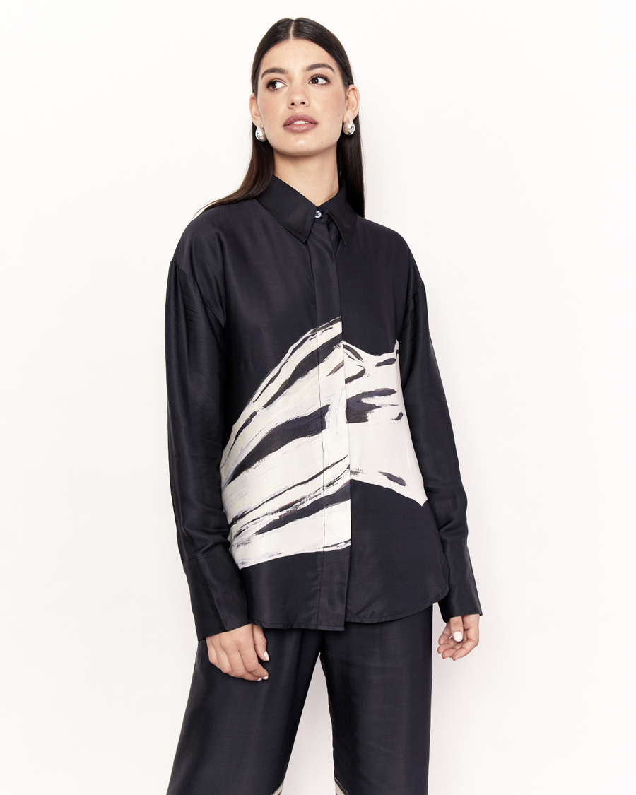 The Hip Hills Long Sleeve Shirt features a button closure and concealed placket, in a relaxed long sleeve edition of our best-selling signature shirt style. It is crafted from a silky recycled Oeko-Tex® certified viscose in the Hip Hills Print, designed in collaboration with Tasmanian artist, Shelley Bickerstaff, in Black and White. Now available at Romy. 