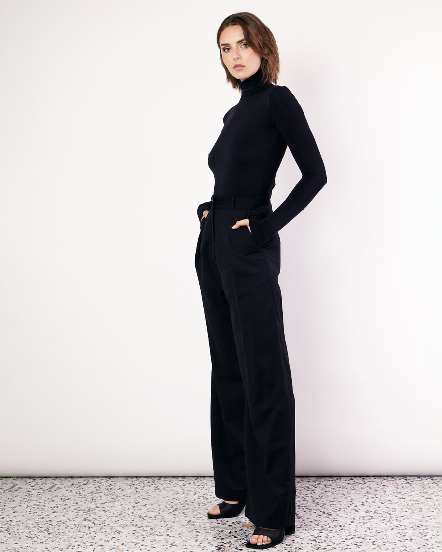 The Stretch Funnelneck is a wardrobe staple to be worn on all occasions, designed to fit close to the body. It is crafted from soft Oeko-Tex® Certified Bamboo Jersey in Black. Now available at Romy. 