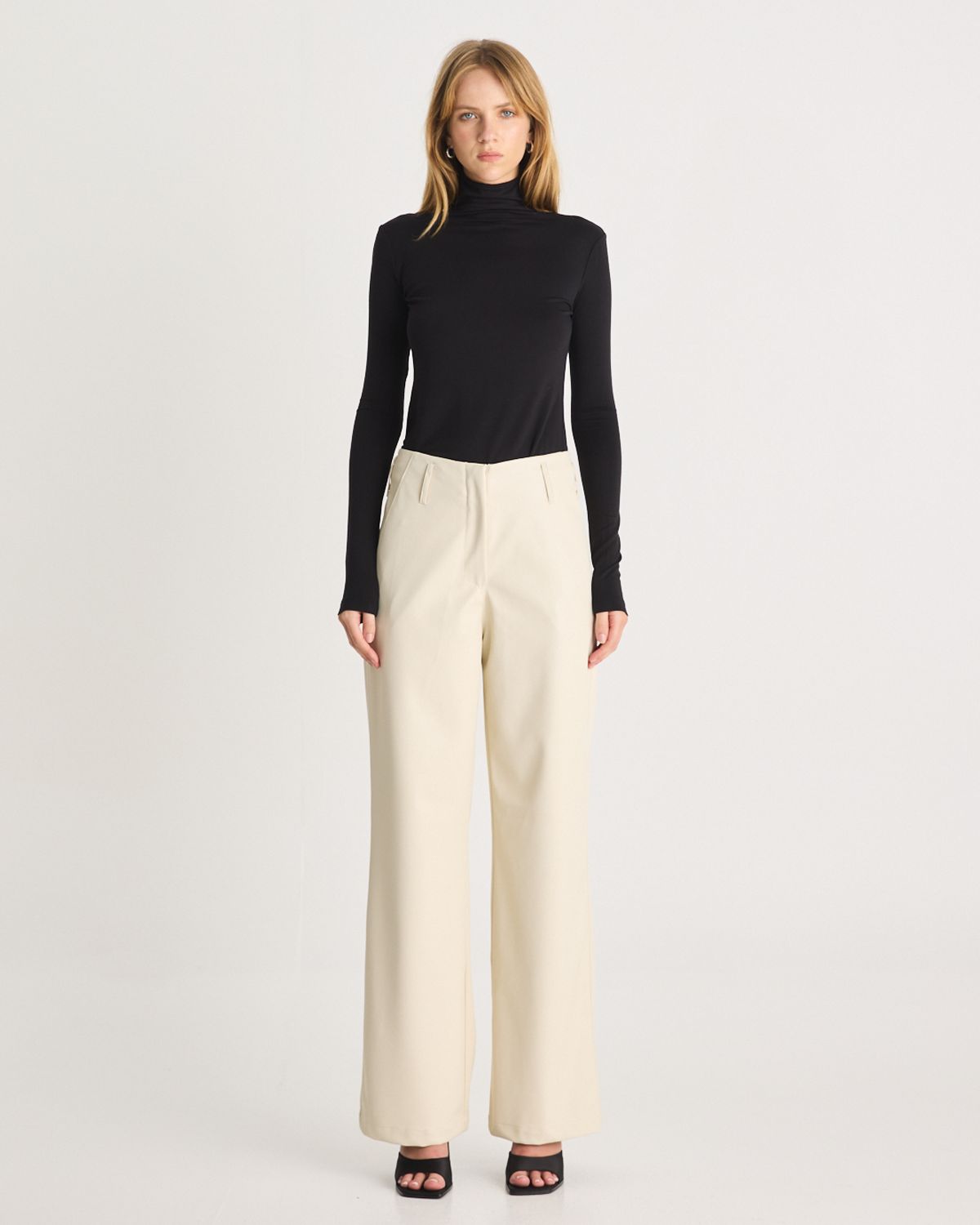 The Vegan Leather Pant are a mid-rise straight leg pant, featuring pockets, belt loops and a hidden clasp closure. They are crafted from a buttery soft Vegan Leather fabrication in Cream. Now available at Romy. 