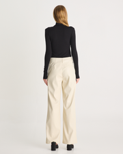 The Vegan Leather Pant are a mid-rise straight leg pant, featuring pockets, belt loops and a hidden clasp closure. They are crafted from a buttery soft Vegan Leather fabrication in Cream. Now available at Romy. 