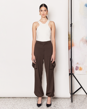 DESCRIPTION: The Cargo Pants offer a modern twist on the 90s Cargo Pant with a parachute silhouette in a rich chocolate brown colour-way. Cut from a soft wool blend with a mid rise waist, the Cargo Pants are a relaxed fit featuring side patch pockets, a concealed hook and bar closure, and elasticated hems. DETAILS: 64% Polyester, 28% Rayon, 6% Wool, 2% SpandexMade in China CARE:Dry Clean Only. SIZE AND FIT: Model is size 8 and wearing a size S. By Romy. 