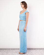The Velvet Maxi Skirt is a figure hugging silhouette that falls to an elegant maxi length. It has an elastic waistband and is crafted from a plush stretch Velvet fabrication in a light Blue hue. Now available at Romy. 