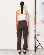 DESCRIPTION: The Cargo Pants offer a modern twist on the 90s Cargo Pant with a parachute silhouette in a rich chocolate brown colour-way. Cut from a soft wool blend with a mid rise waist, the Cargo Pants are a relaxed fit featuring side patch pockets, a concealed hook and bar closure, and elasticated hems. DETAILS: 64% Polyester, 28% Rayon, 6% Wool, 2% SpandexMade in China CARE:Dry Clean Only. SIZE AND FIT: Model is size 8 and wearing a size S. By Romy. 