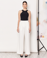 The Pleat Front Pant are a wardrobe staple, wide-leg pant in a light cream colourway. Crafted with a soft wool blend, these pants are fully-lined and non-sheer, featuring a hidden clasp closure, a slightly wide leg, two deep side pockets, and a pleated detail down the front to create a subtle draped silhouette. DETAILS:Main: 73% Polyester, 18% Rayon, 6% Wool, 3% SpandexLining: 96% Polyester, 4% SpandexMade in China CARE:Dry Clean Only. SIZE AND FIT:Model is size 8 and wearing a size S. By Romy. 