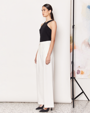 The Pleat Front Pant are a wardrobe staple, wide-leg pant in a light cream colourway. Crafted with a soft wool blend, these pants are fully-lined and non-sheer, featuring a hidden clasp closure, a slightly wide leg, two deep side pockets, and a pleated detail down the front to create a subtle draped silhouette. DETAILS:Main: 73% Polyester, 18% Rayon, 6% Wool, 3% SpandexLining: 96% Polyester, 4% SpandexMade in China CARE:Dry Clean Only. SIZE AND FIT:Model is size 8 and wearing a size S. By Romy. 