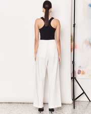 The Pleat Front Pant are a wardrobe staple, wide-leg pant in a light cream colourway. Crafted with a soft wool blend, these pants are fully-lined and non-sheer, featuring a hidden clasp closure, a slightly wide leg, two deep side pockets, and a pleated detail down the front to create a subtle draped silhouette. DETAILS:Main: 73% Polyester, 18% Rayon, 6% Wool, 3% SpandexLining: 96% Polyester, 4% SpandexMade in China CARE:Dry Clean Only. SIZE AND FIT:Model is size 8 and wearing a size S. By Romy. 