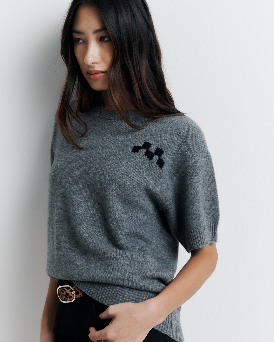 Shop the Cleo Short Sleeve Sweater made from a luxurious 90% wool and 10% cashmere blend. Featuring a relaxed fit, dropped shoulders, crew neck, and ribbed hem detailing, this lightweight, breathable sweater adds comfort and style to your wardrobe. Perfect for layering or wearing on its own.