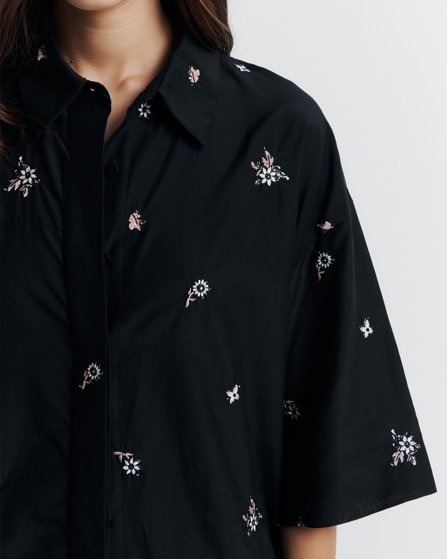 The June Shirt is an oversized short sleeve button-up featuring a concealed placket, exaggerated sleeves, and delicate floral embroidery for a subtle romantic touch. Pair it with the matching pant or wear it open over a tank for easy styling. Shop now.