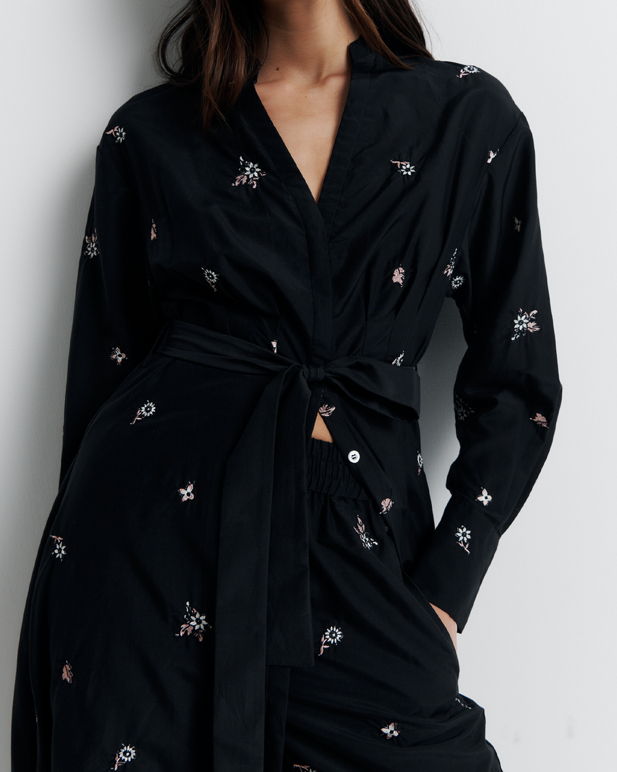 The Lola Shirt Dress is a lightweight, button-through shirtdress featuring pleated waist detailing, a removable belt, and delicate floral embroidery for a romantic, feminine finish.