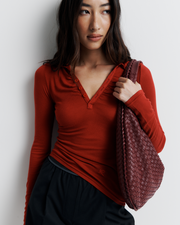 The Louise Knit Top in Red is a collared Henley-style knit featuring soft bust gathers, elongated sleeves for layering, and signature ‘R’ embroidery—an effortlessly polished wardrobe essential.