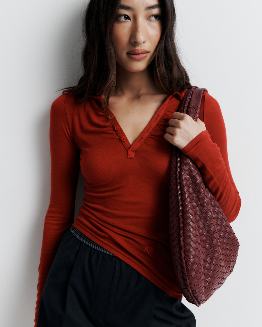 The Louise Knit Top in Red is a collared Henley-style knit featuring soft bust gathers, elongated sleeves for layering, and signature ‘R’ embroidery—an effortlessly polished wardrobe essential.