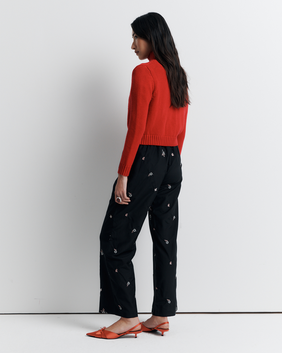 The Lara Cardigan is a fitted, collared knit featuring delicate floral motifs and a timeless button-front design—perfect for layering with a touch of vintage charm.