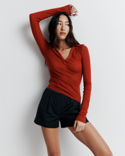 The Louise Knit Top in Red is a collared Henley-style knit featuring soft bust gathers, elongated sleeves for layering, and signature ‘R’ embroidery—an effortlessly polished wardrobe essential.