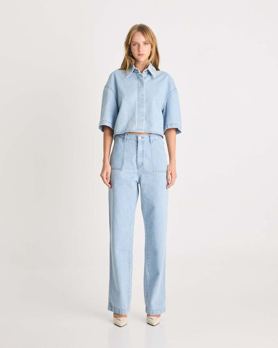 This Denim Shirt is a take on a Romy Classic in a light blue wash in a 100% cotton. It an elevated take on your staple denim shirt that can be styled fastened or open over any dress or tank. Shop now.