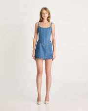 This mini length denim dress features a specially designed lace up corset detail on the back, scooped neckline, scuba panels through the side waist and a lightweight denim fabric to keep you comfortable all day. Perfect for any summer party. Shop now.