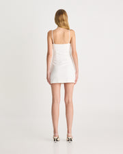 Crafted from a mid-weight linen fabric, offering a relaxed fitting shape, the Embroidered Mini Dress in White is the perfect warm-weather dress. Featuring adjustable spaghetti straps, straight neck design and tucks through the waist that create a flattering fit. Now available at www.romythebrand.com