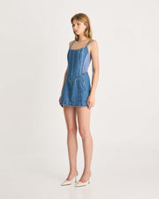 This mini length denim dress features a specially designed lace up corset detail on the back, scooped neckline, scuba panels through the side waist and a lightweight denim fabric to keep you comfortable all day. Perfect for any summer party. Shop now.