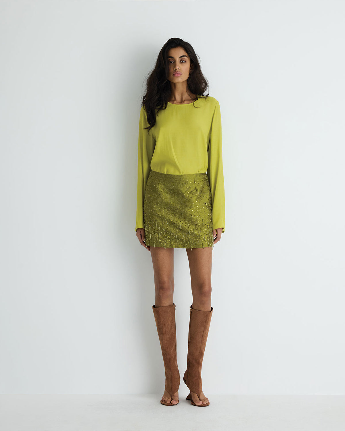 Celestine Mini in chartreuse silk with hand beading, front view on model.