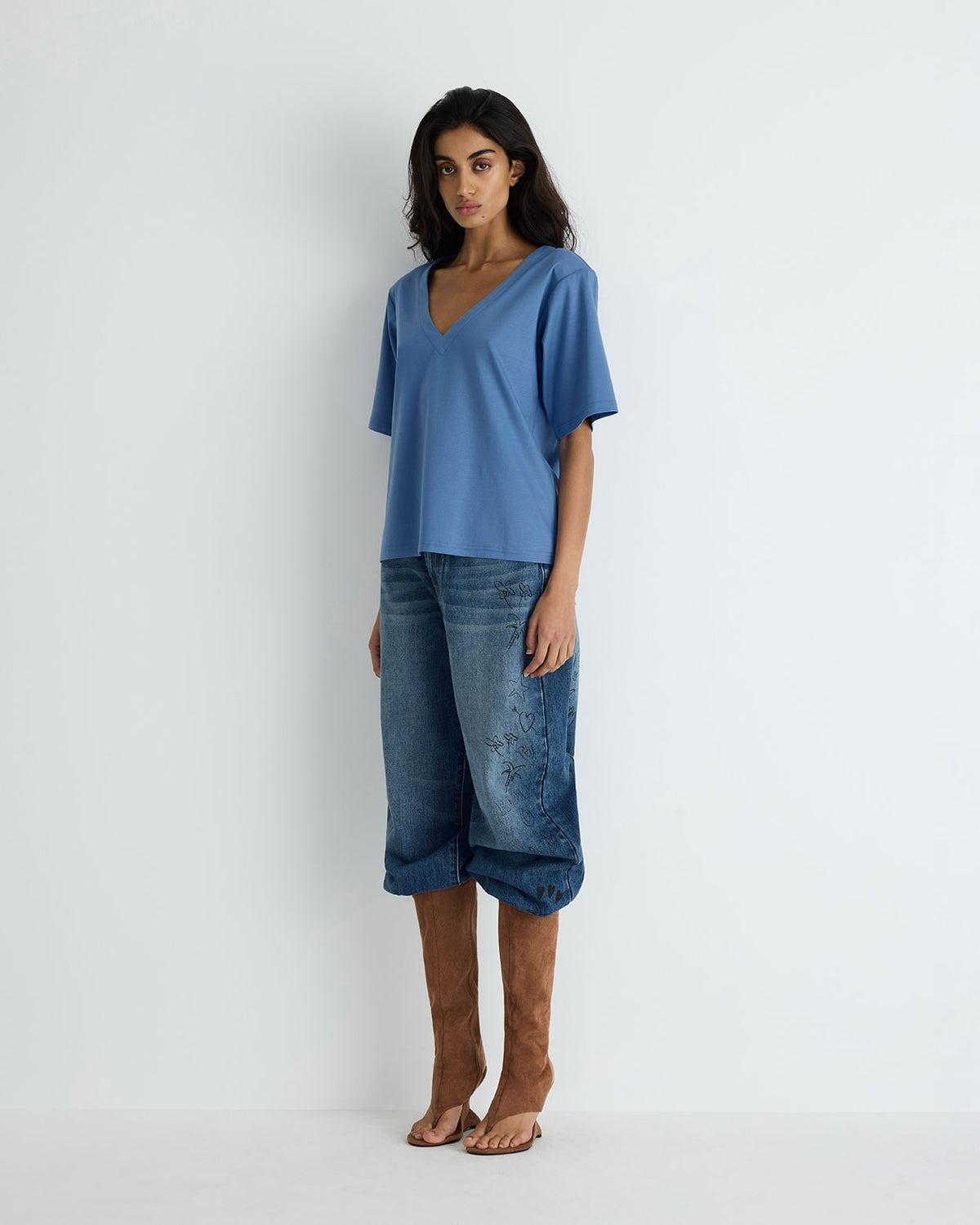 Clove Tee in blue, side view on model.