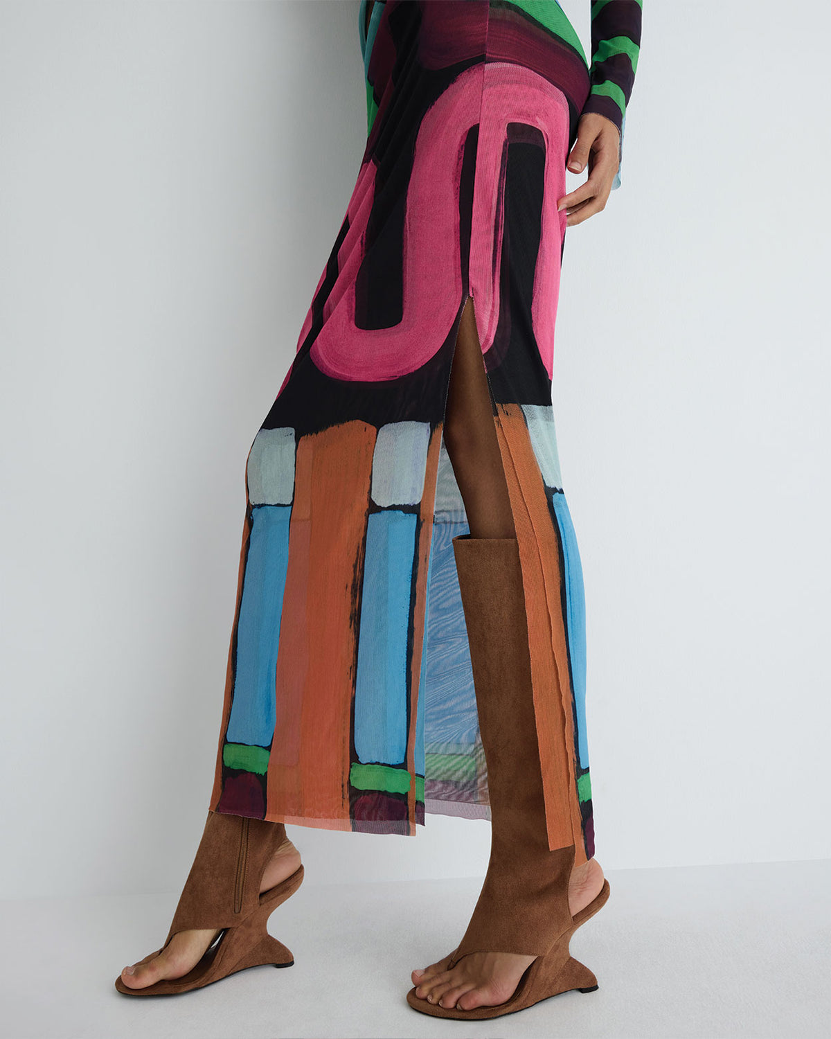 Portia Dress in multicolour print polyester mesh, back split detail on model.