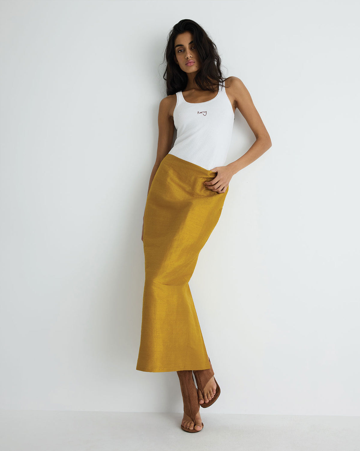 Veda Skirt in gold raw silk, front close-up on model.