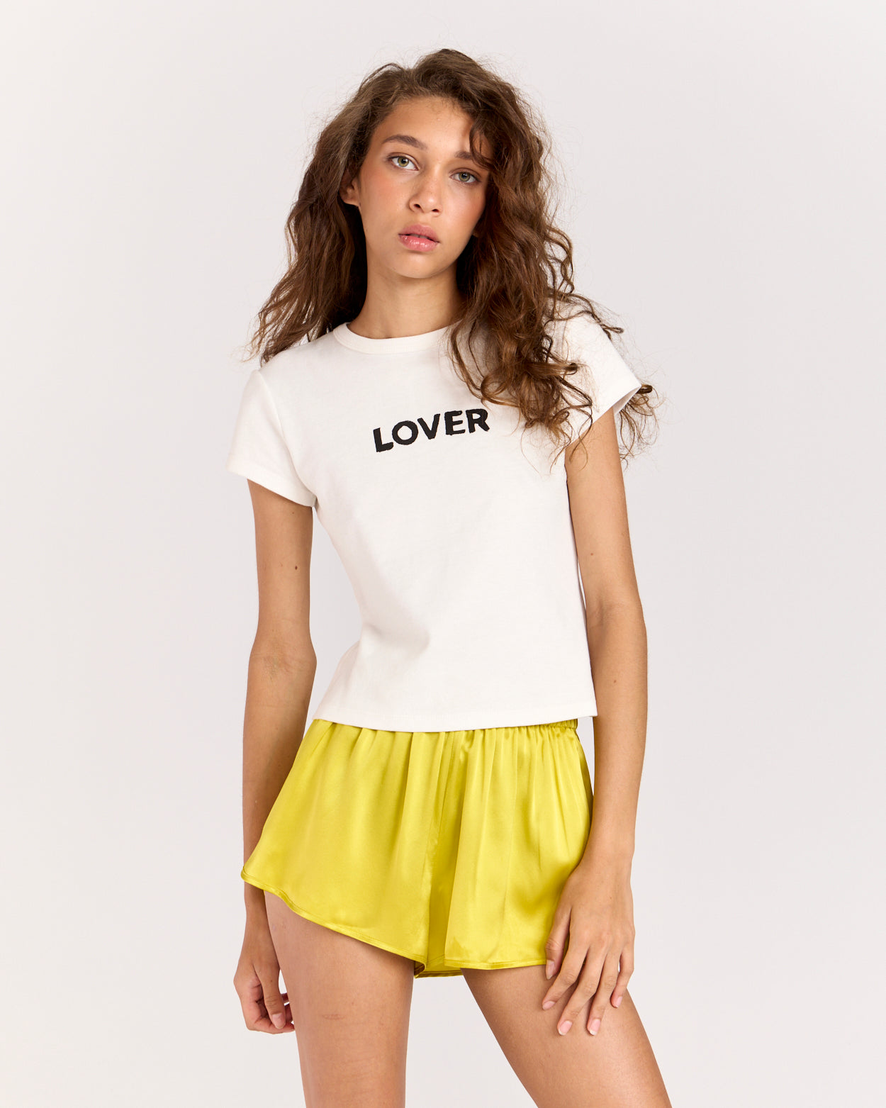 Discover the Lover Baby Tee, a timeless favorite with a classic crewneck, cropped silhouette, and fitted short-sleeve design. Crafted from 100% organic cotton for a super-soft feel, it's perfect for effortless everyday wear.