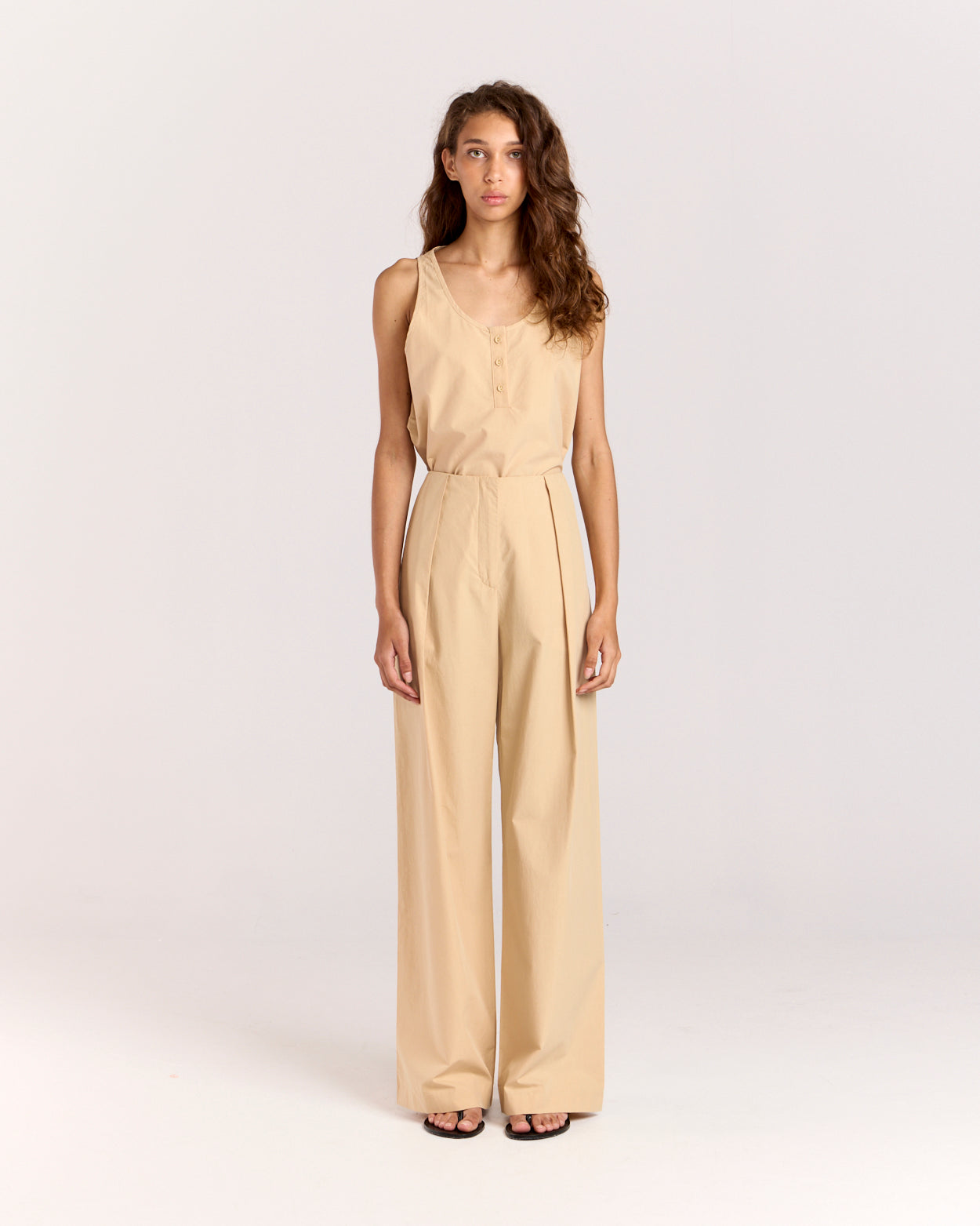 Elevate your wardrobe with the Summer Pant, a classic piece with a modern edge. Fitted at the waist and hips, it transitions into a relaxed straight-leg silhouette that elongates your figure. Crafted from soft, lightweight cotton-tencel, it features side pockets, a concealed zip, and back welt pockets for added functionality.