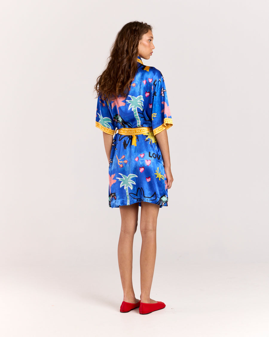 Discover the Lover Robe, a relaxed shirt-style mini dress exclusive to Romy, featuring Jake Pedro's Lover Print. Crafted from matte viscose rayon twill, it includes a button front and a removable Romy belt tie for versatile, effortless style.