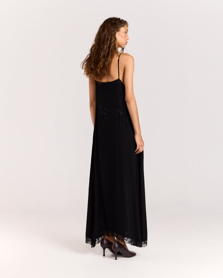 Step into elegance with this black maxi dress featuring contrast floral lace detail through the front to accentuate the waist. Crafted from matte satin, the relaxed silhouette falls gracefully with a side split and lace trim, finished with adjustable straps for a perfect fit.