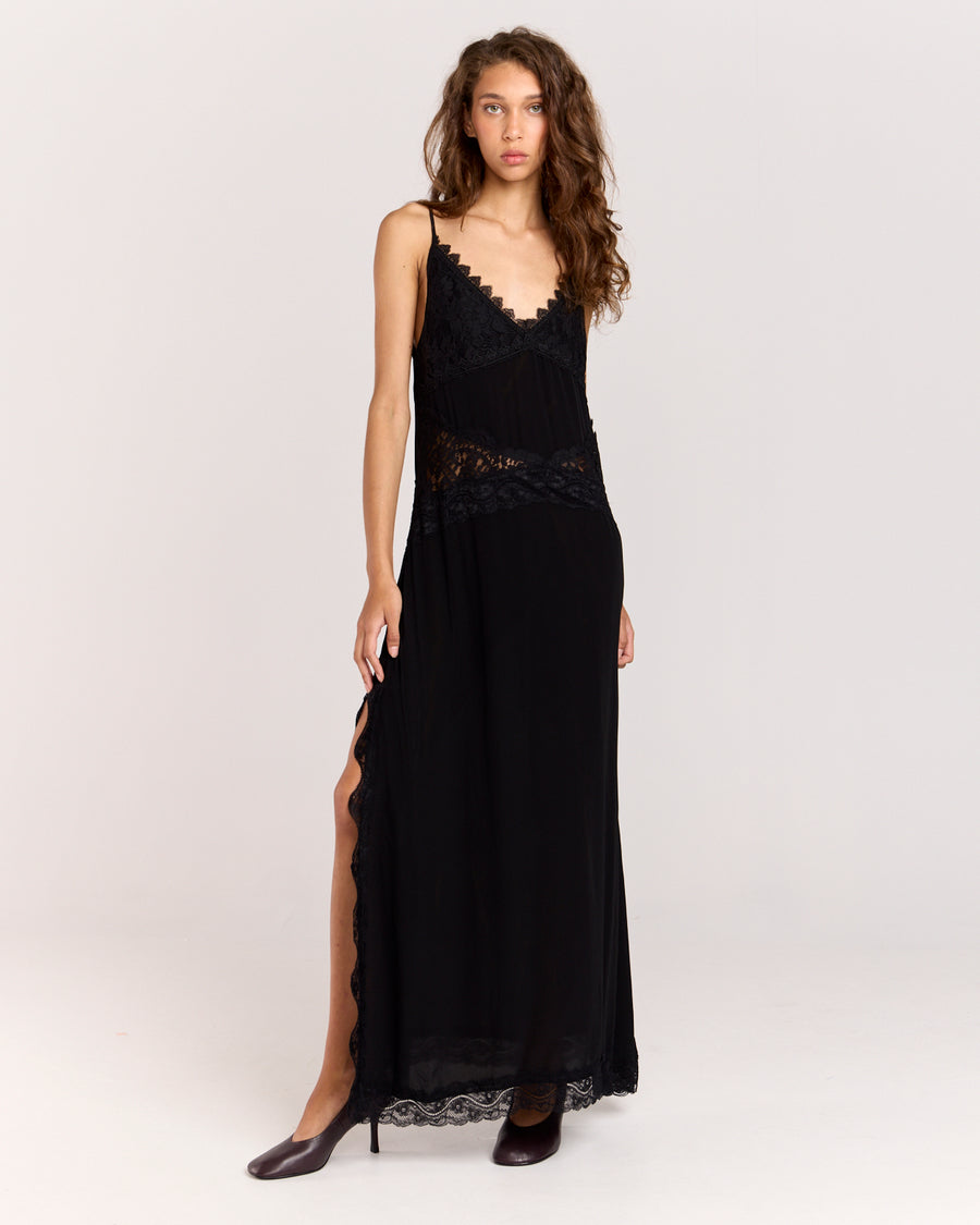 Step into elegance with this black maxi dress featuring contrast floral lace detail through the front to accentuate the waist. Crafted from matte satin, the relaxed silhouette falls gracefully with a side split and lace trim, finished with adjustable straps for a perfect fit.