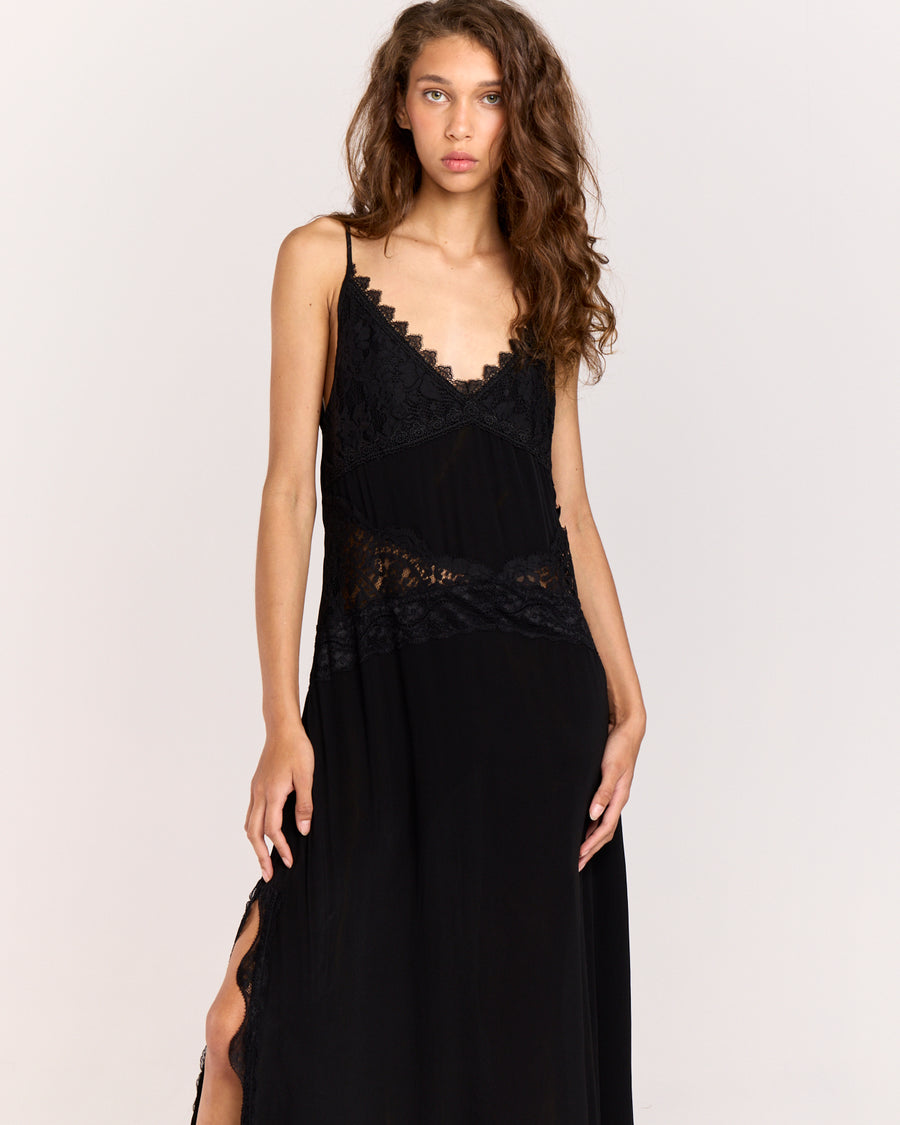 Step into elegance with this black maxi dress featuring contrast floral lace detail through the front to accentuate the waist. Crafted from matte satin, the relaxed silhouette falls gracefully with a side split and lace trim, finished with adjustable straps for a perfect fit.